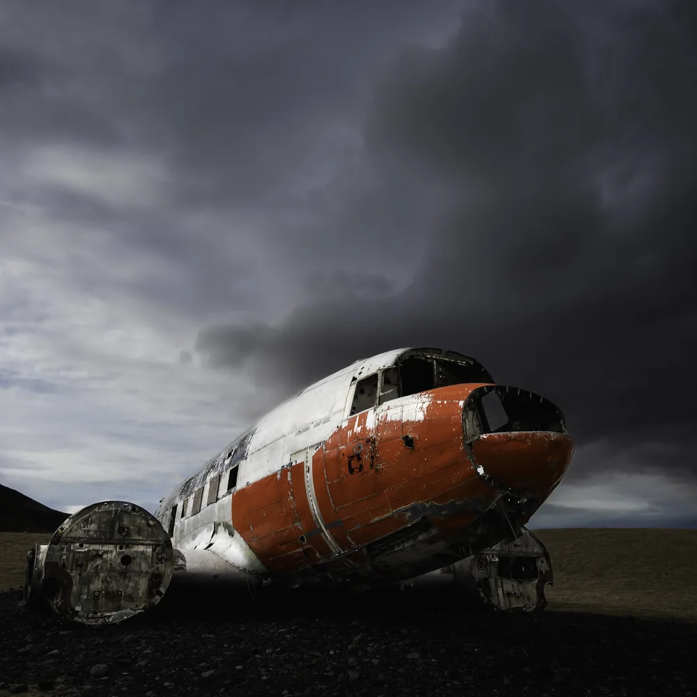 The assembled DC-3 aircraft beneath dramatic skies at Eyvindarholt