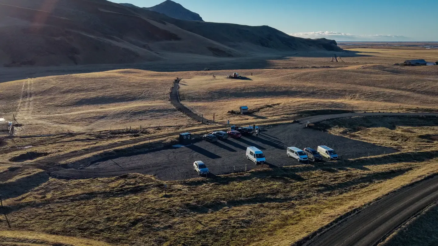 Aerial view of the Eyvindarholt parking area and the path to the DC-3 beneath the South Iceland hills