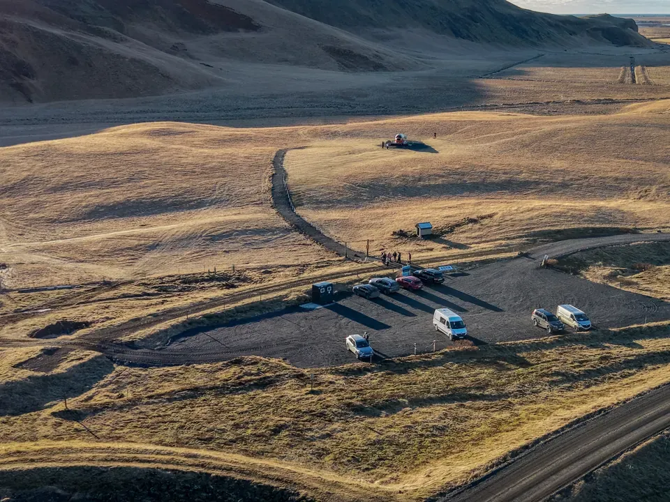Aerial view of the designated parking area and the path toward the aircraft at Eyvindarholt