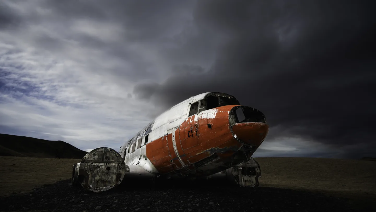 The assembled orange nose and wing of the DC-3 at Eyvindarholt beneath dramatic skies